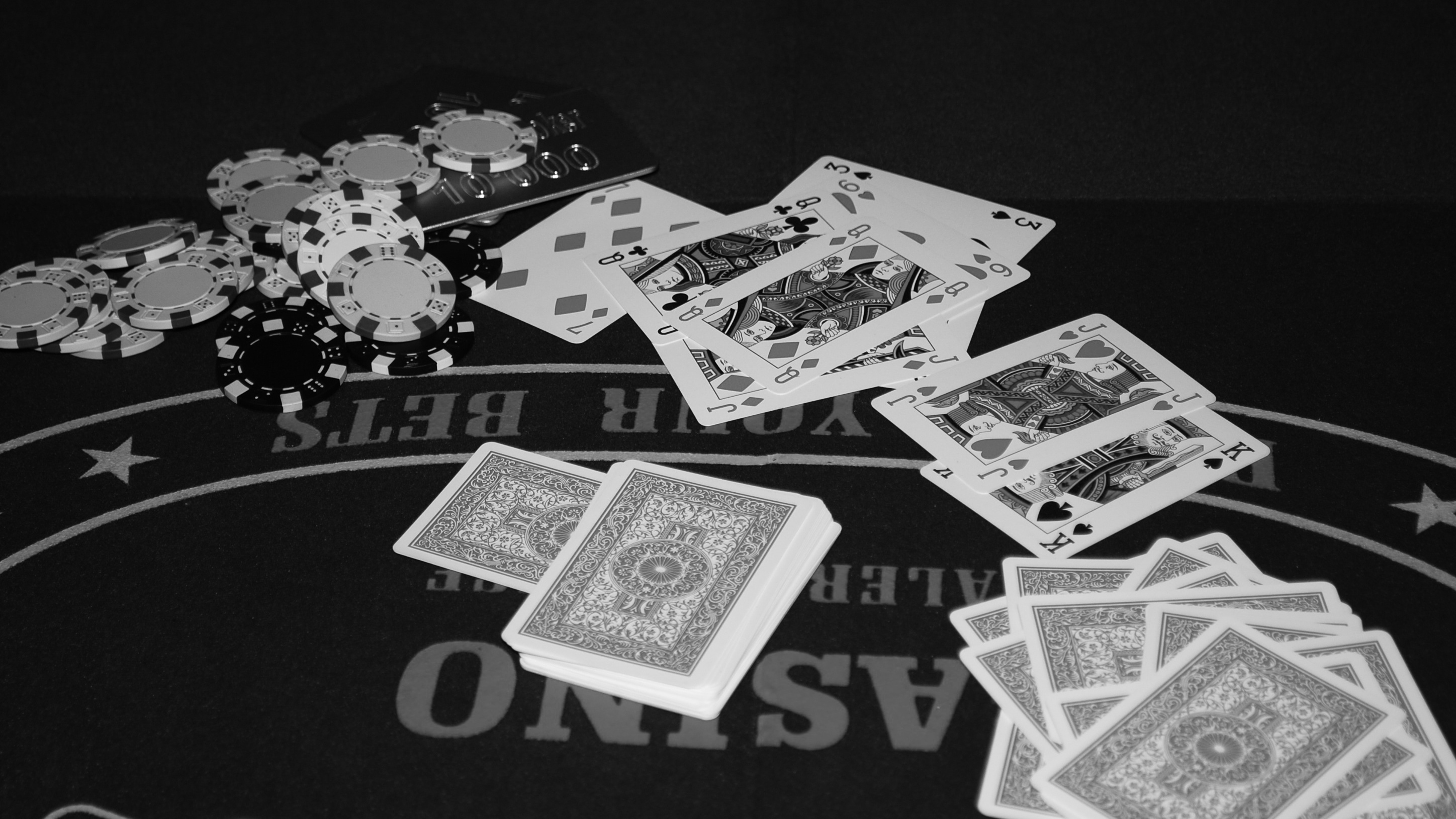 Black-and-white still life of playing cards and chips on a felt table, photographed on 19 September 2008.